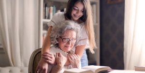 A teenager embraces her grandmother